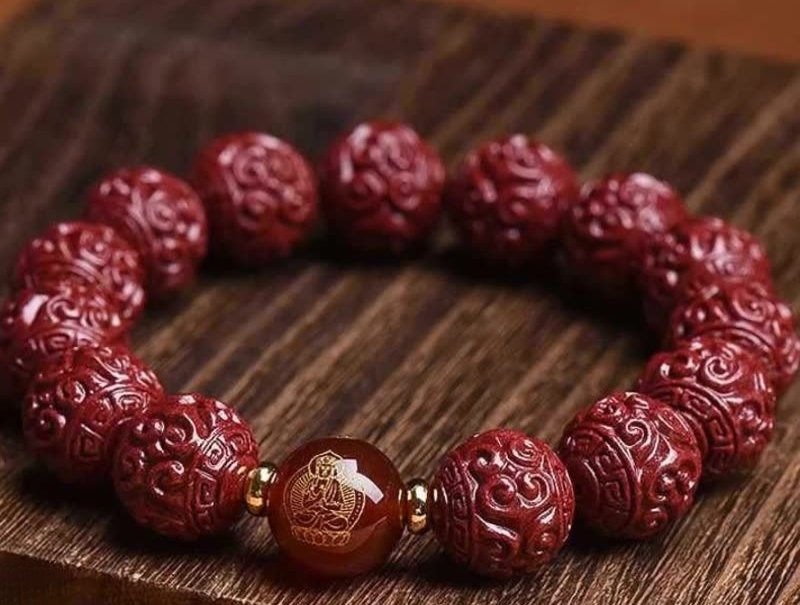 Buddha jewelry:The Raw Cinnabar Bracelet, or Zodiac Buddha Bracelet, features raw cinnabar beads paired with twelve zodiac animal beads, red agate accents, and symbols of the Eight Guardians. Raw cinnabar offers protection, while zodiac beads and the Zodiac Buddha connection personalize the piece. Red agate adds vitality, and the Eight Guardians provide balanced protection. Crafted with intention, it serves as both a spiritual talisman and a striking accessory, rich in cultural and symbolic depth.