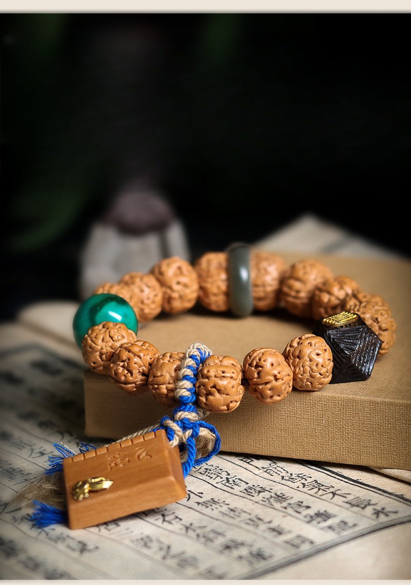 Buddha jewelry:The Nepalese Rudraksha Prayer Bead Bracelet, a Tibetan ethnic-style women’s accessory, features sacred Rudraksha beads paired with Tibetan silver spacers, turquoise/coral accents, and traditional knotwork. Revered for spiritual properties, the beads are complemented by symbols of Himalayan culture, crafted by hand for an artisanal touch. Designed for women, it balances elegance with practicality, serving as both a devotional tool and a stylish accessory that honors Tibetan heritage.