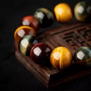 Buddha jewelry:The Natural Tiger's Eye Stone Bracelet, or Tiger Eye Crystal Bracelet, features polished tiger's eye stones known for their golden-brown hues and chatoyant "cat's eye" effect. Valued for both its aesthetic appeal and metaphysical properties, the stone enhances personal power, clarity, and protection, while balancing the solar plexus chakra. Available in various designs with versatile styling, it serves as both a striking accessory and a tool for grounding, confidence, and mindfulness. Crafted to honor the stone's natural beauty, it offers timeless elegance with tangible energetic benefits.